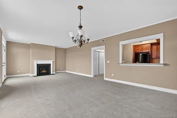 a view of an empty room with a fireplace