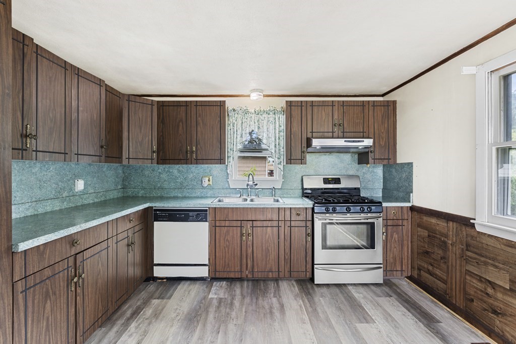 10 Fitzpatrick Avenue Brockton, MA 02301 - Photo 7 of 34 a kitchen with stainless steel appliances granite countertop a stove a sink dishwasher and a refrigerator