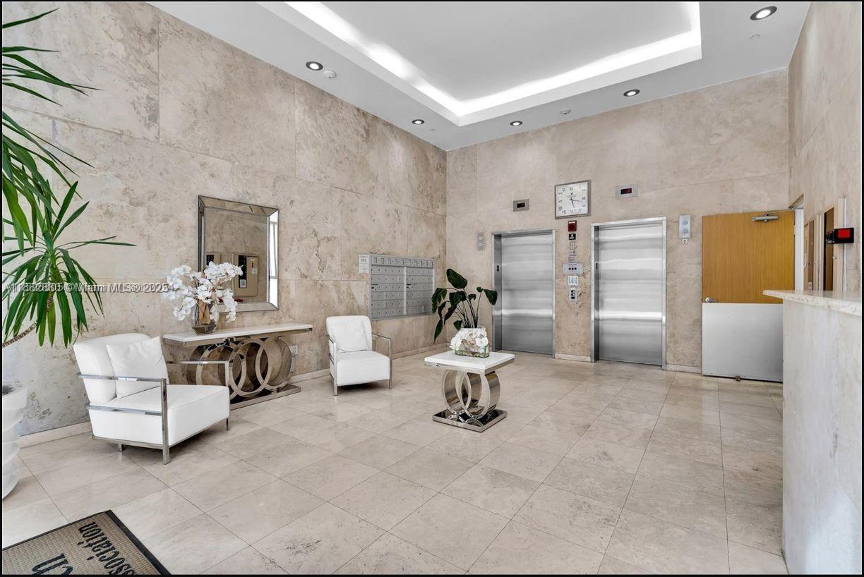 8911 Collins Avenue, Unit 203 Surfside, FL 33154 - Photo 7 of 10 a living room with furniture and a couch