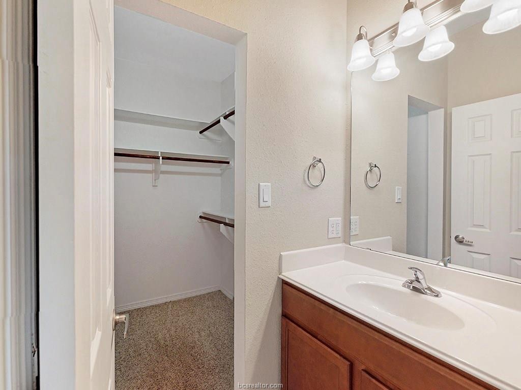 1198 Jones-Butler Road, Unit 2607 College Station, TX 77840 - Photo 19 of 26 a bathroom with a sink vanity granite and a mirror