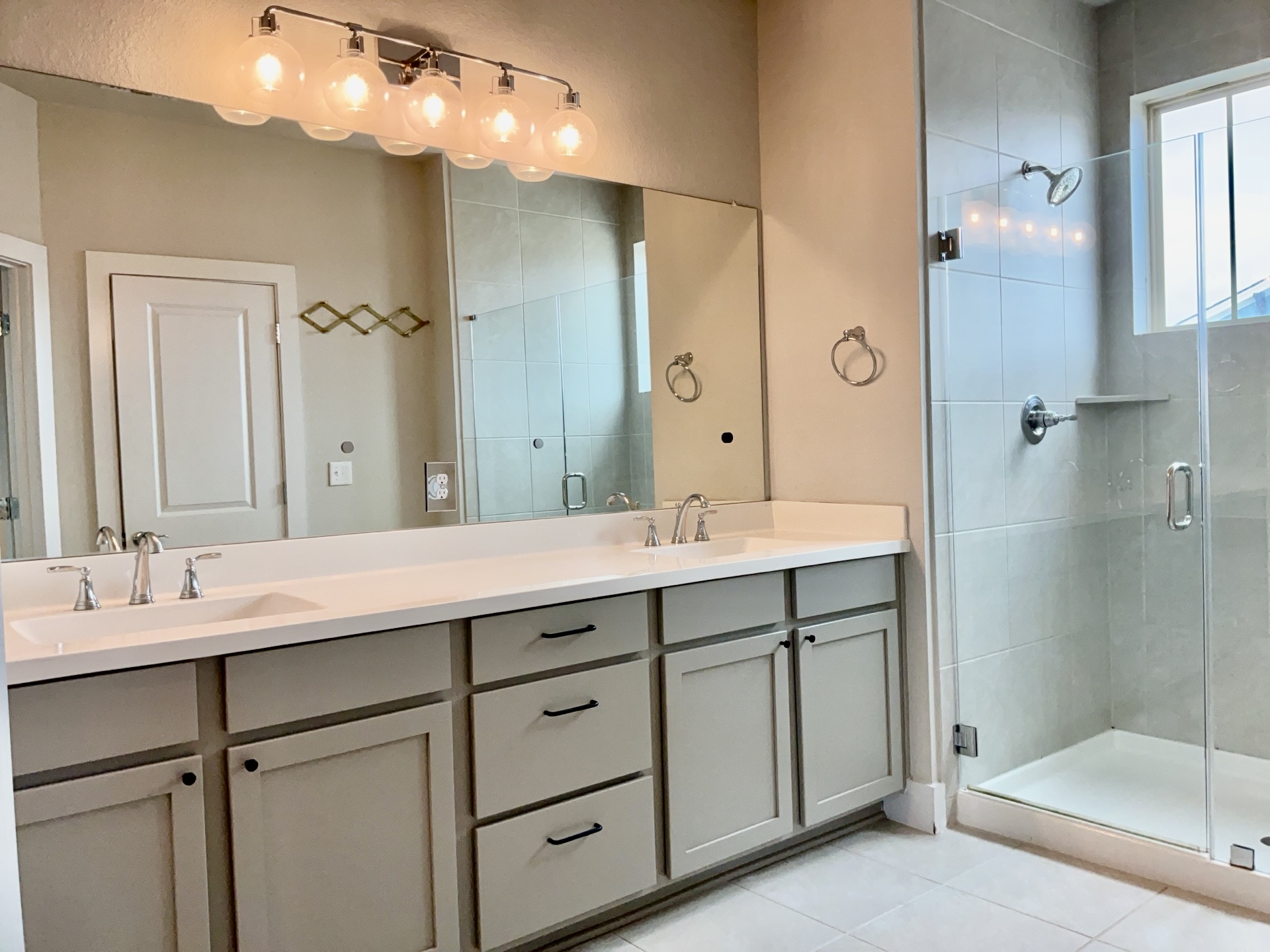 8315 Laughlin Lane Austin, TX 78744 - Photo 11 of 23 Full bathroom featuring double vanity, a stall shower, and light tile patterned floors