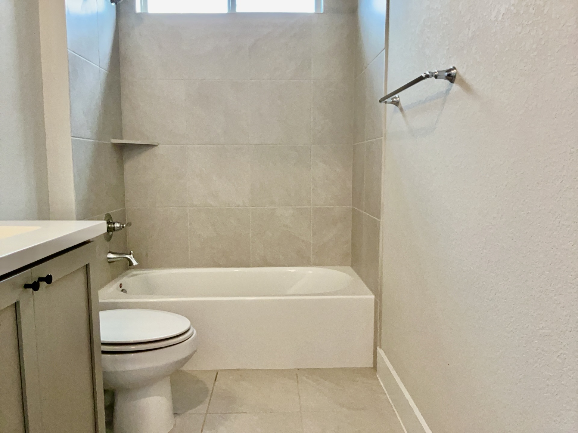 8315 Laughlin Lane Austin, TX 78744 - Photo 16 of 23 Full bath with a textured wall, vanity, bathtub / shower combination, and light tile patterned flooring