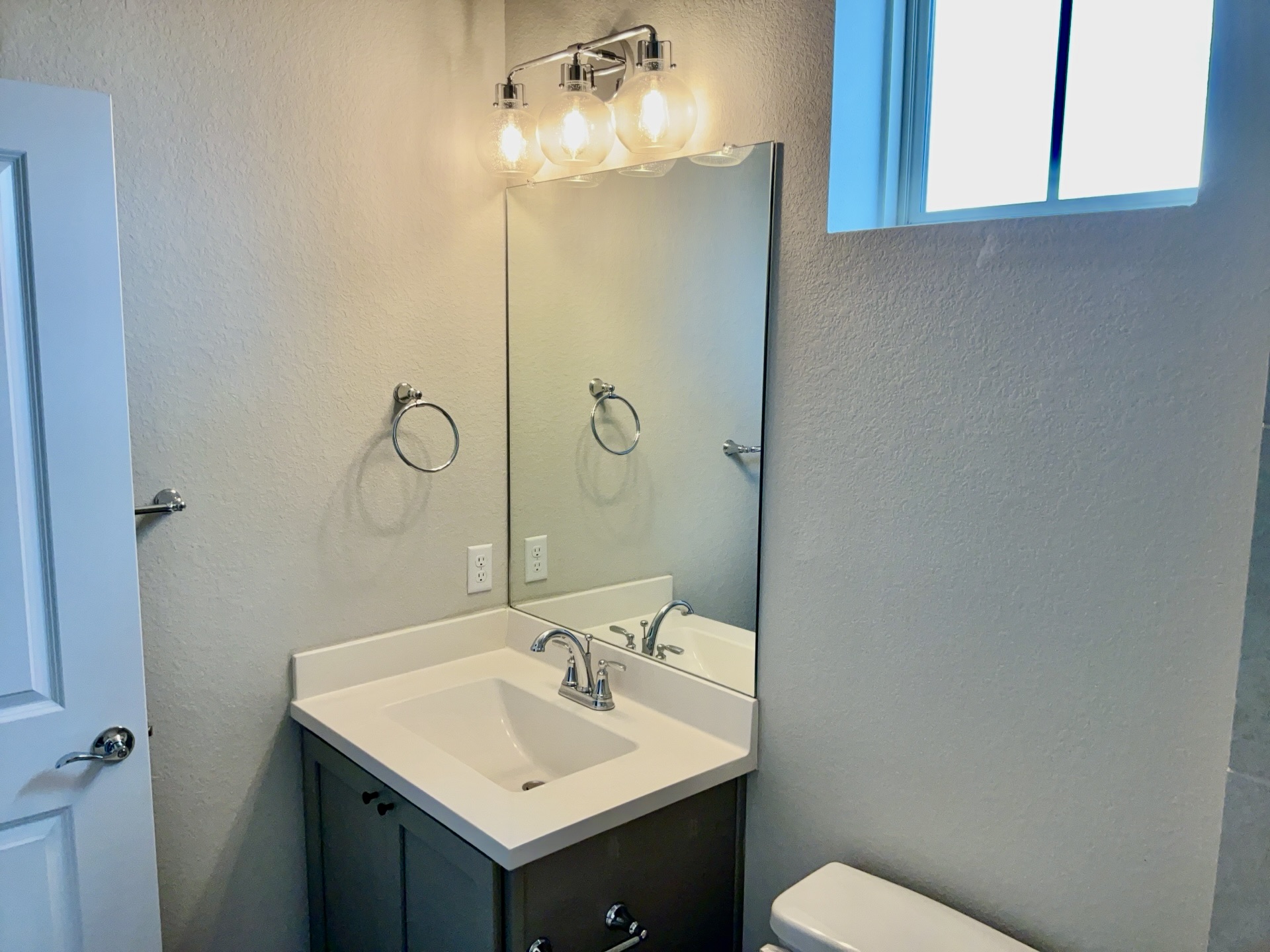 8315 Laughlin Lane Austin, TX 78744 - Photo 19 of 23 Bathroom featuring a textured wall and vanity