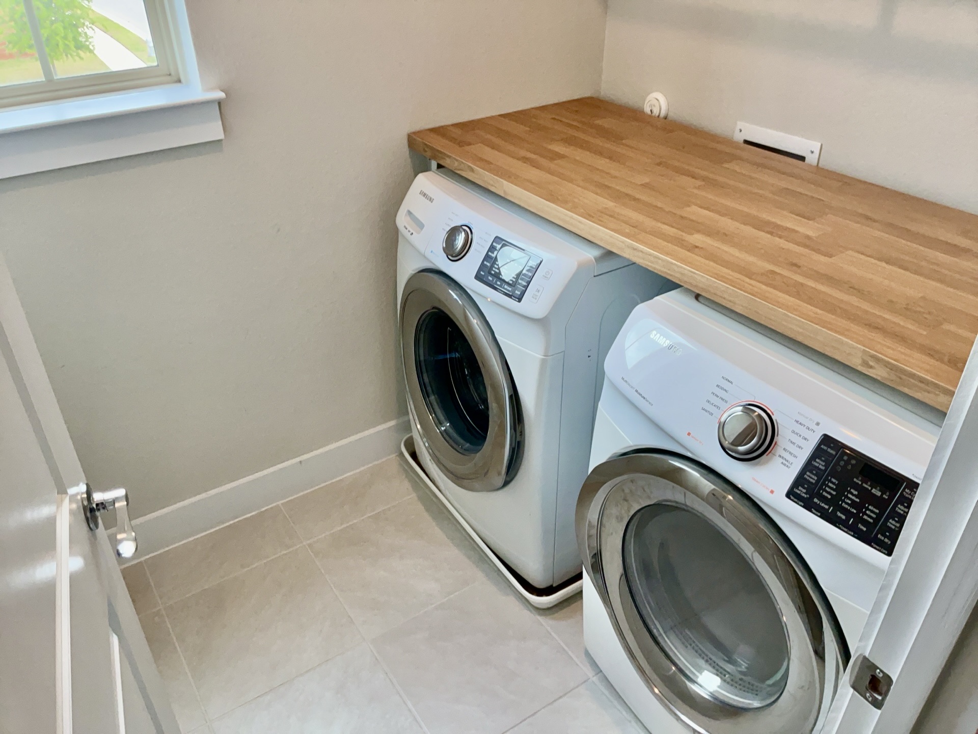 8315 Laughlin Lane Austin, TX 78744 - Photo 20 of 23 Laundry room featuring light tile patterned flooring and washer and dryer