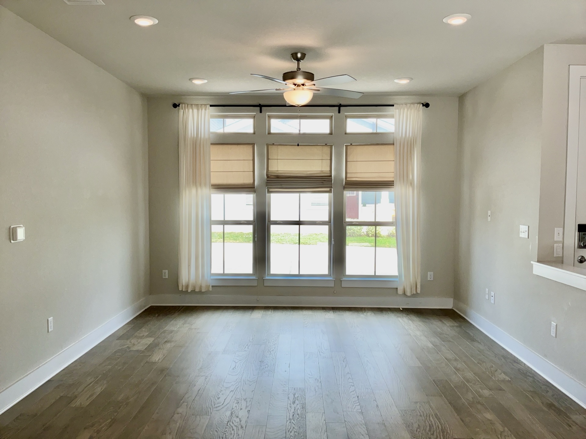 8315 Laughlin Lane Austin, TX 78744 - Photo 3 of 23 Living Room featuring ceiling fan, dark wood-style flooring, recessed lighting, and healthy amount of natural light