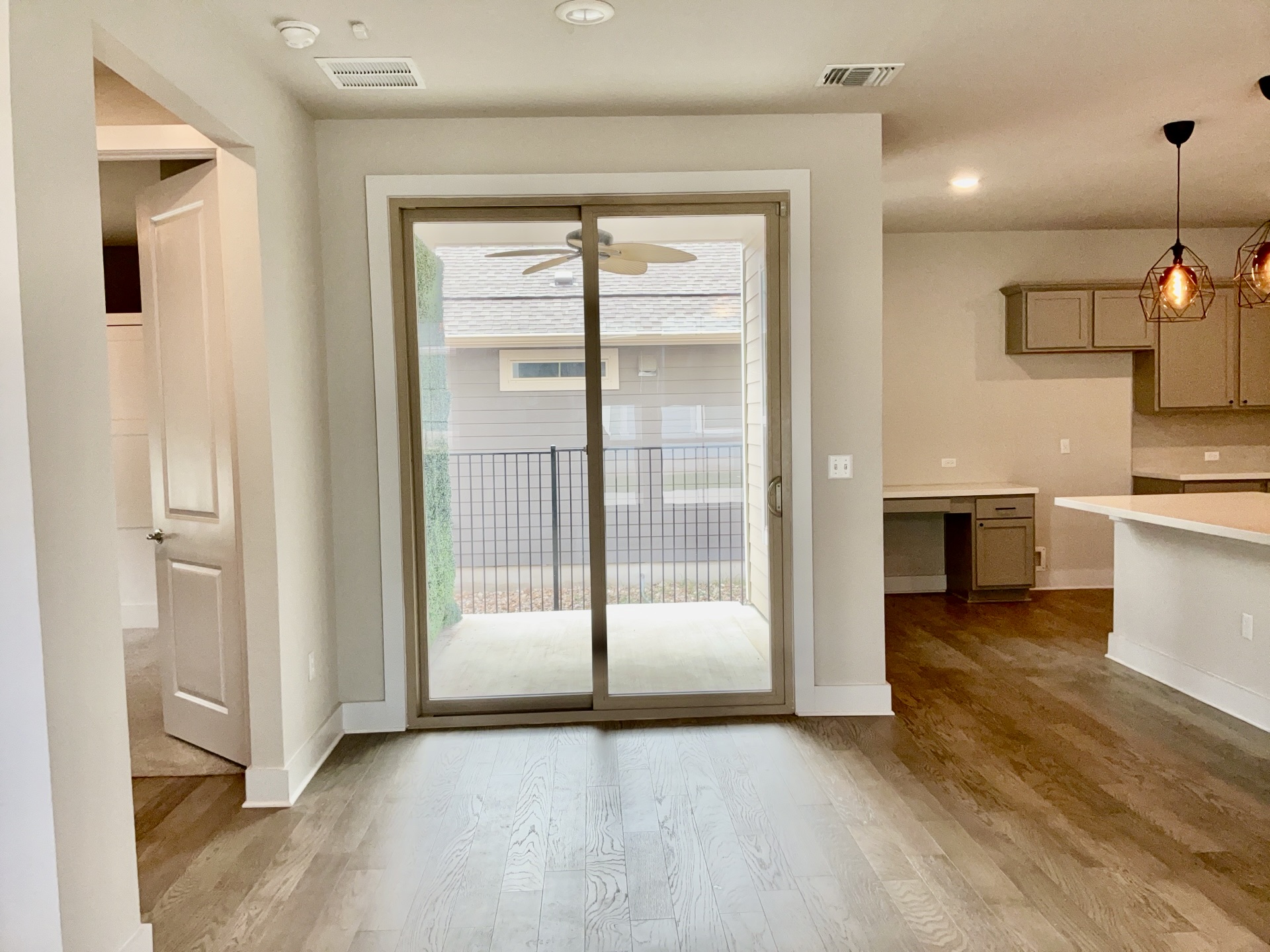 8315 Laughlin Lane Austin, TX 78744 - Photo 8 of 23 Dining Room with wood finished floors, ceiling fan, built in desk, and recessed lighting