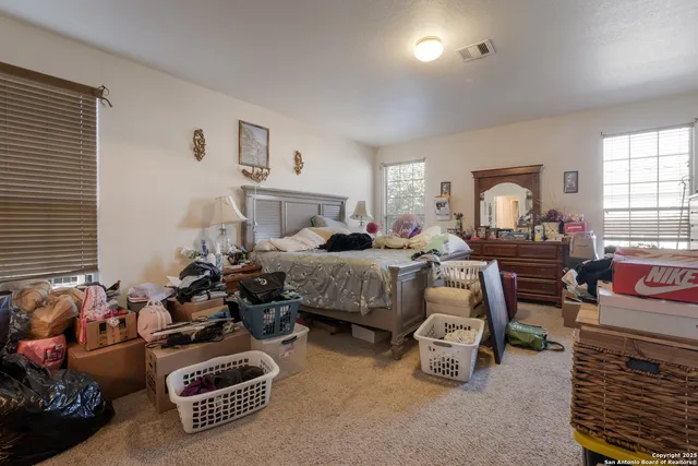 a bedroom with furniture and a window