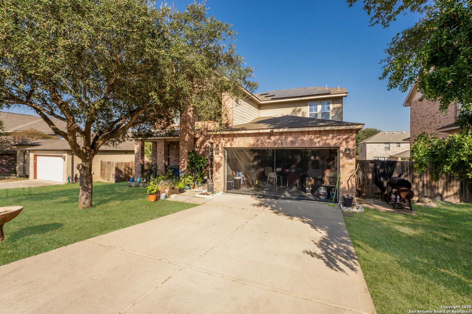 144 Springtree Bluff Cibolo, TX 78108 - Photo 2 of 37 a view of a house with a patio and a garden