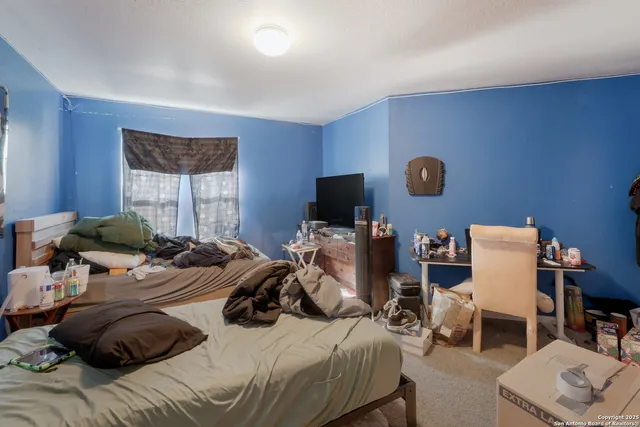 a bedroom with a bed and a window