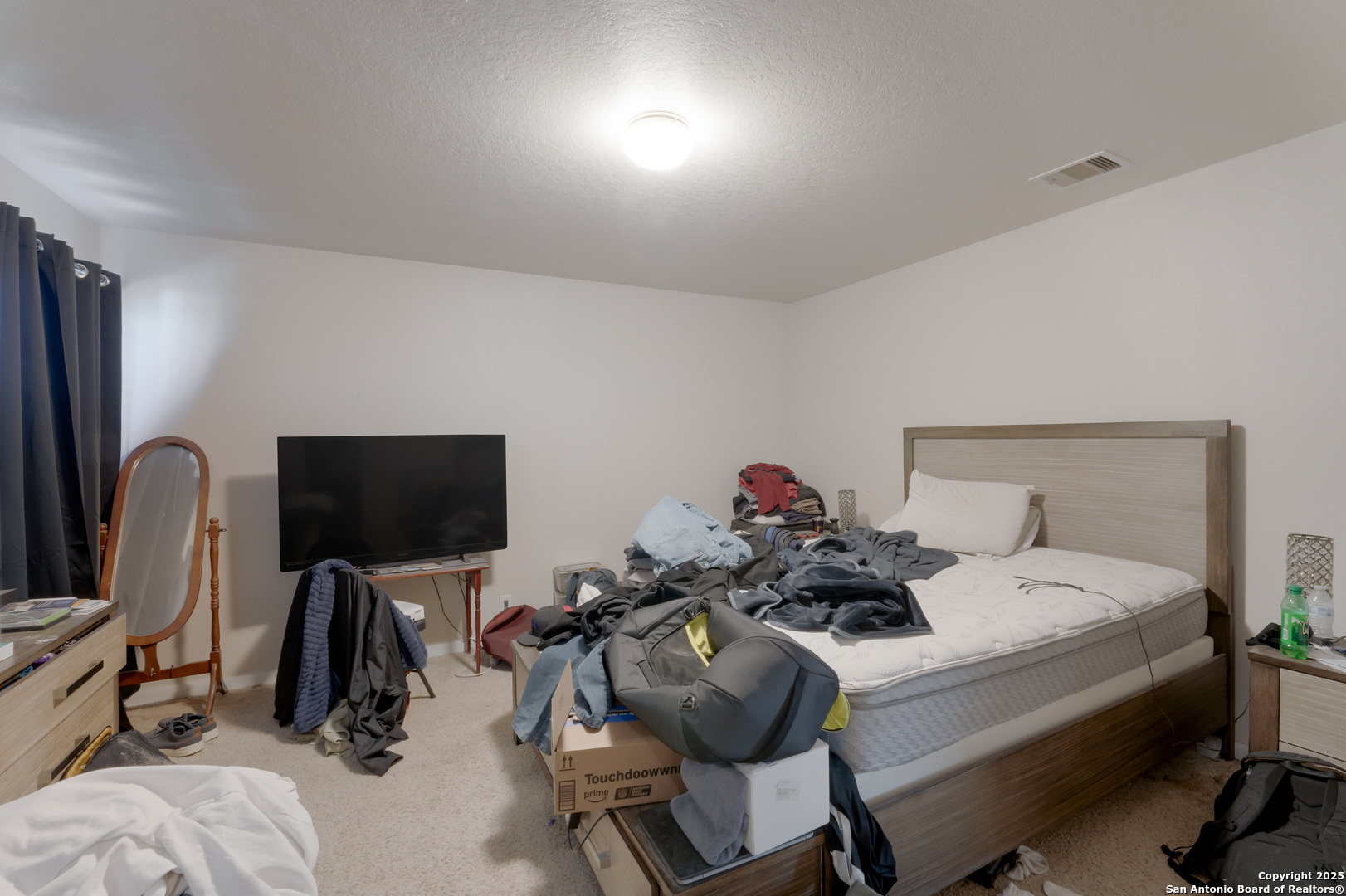 144 Springtree Bluff Cibolo, TX 78108 - Photo 26 of 37 a bedroom with bed and a flat tv screen on the dresser