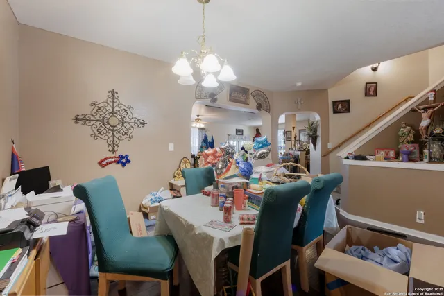 a view of a dining room with furniture and chandelier