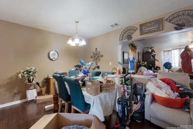 a view of a dining room with furniture and chandelier