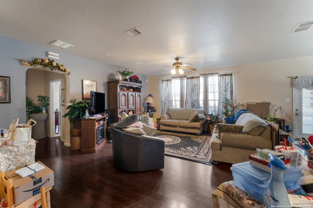 a living room with furniture fireplace and wooden floor