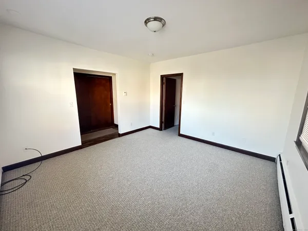 a view of an empty room and a window
