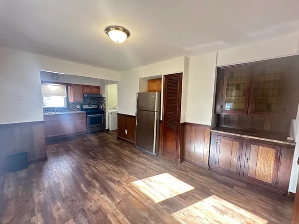 a kitchen with granite countertop stainless steel appliances refrigerator and cabinets