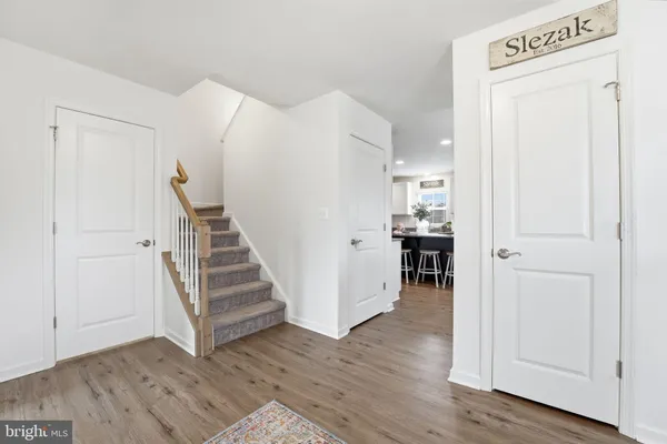 a view of a hallway with wooden floor and entryway