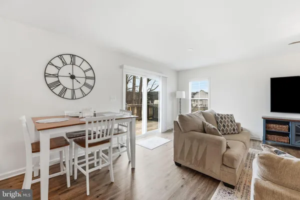 a living room with furniture a flat screen tv and a large window