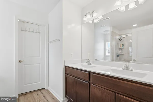 a bathroom with a double vanity sink and a mirror