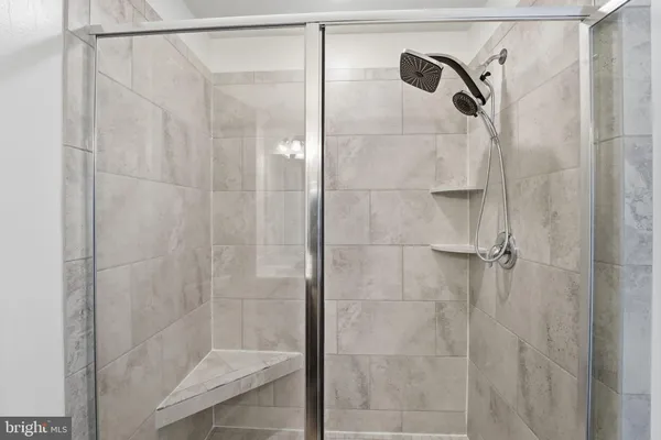 a bathroom with a glass shower door