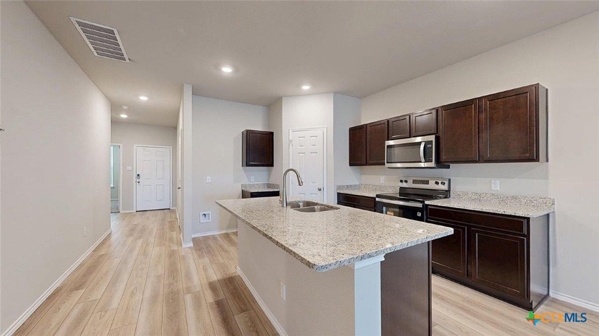 1111 Stone Vly Road Temple, TX 76502 - Photo 7 of 21 a kitchen with a sink microwave and refrigerator