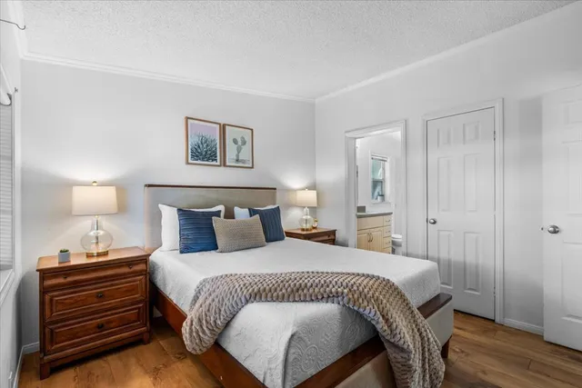 a bedroom with a bed and a night stand