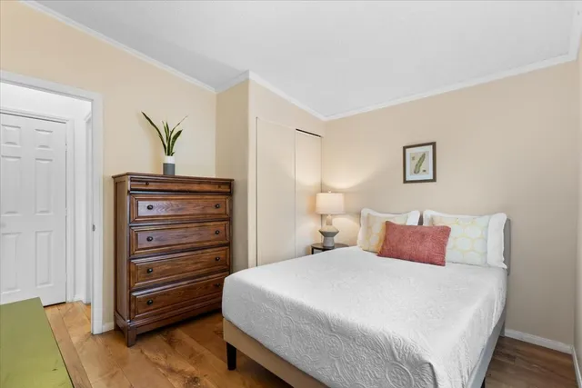 a bedroom with a bed and a dresser