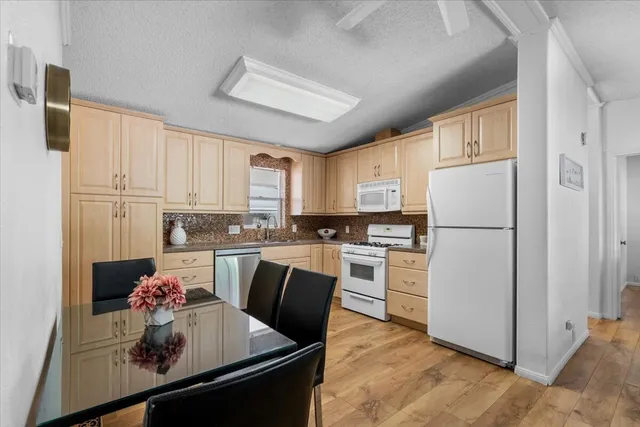 a kitchen with refrigerator cabinets and wooden floor