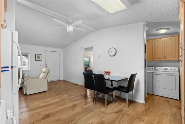 a view of a dining room with furniture and wooden floor