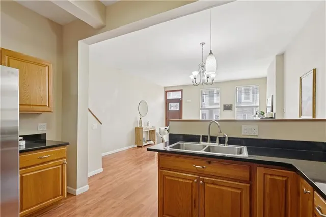 a kitchen with stainless steel appliances granite countertop a stove a refrigerator and a refrigerator