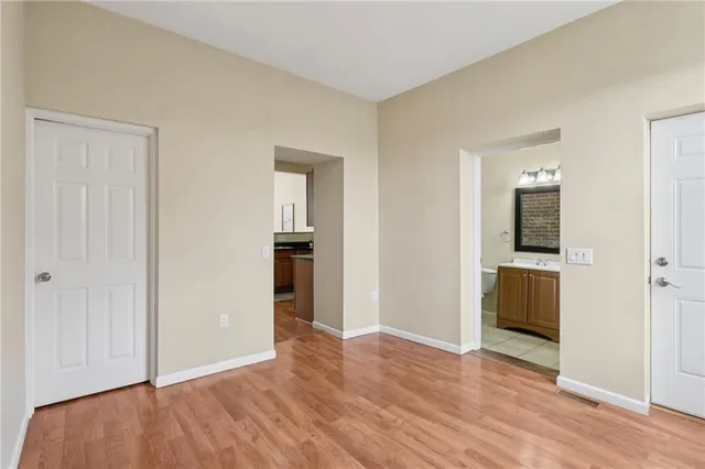 an empty room with windows and closet