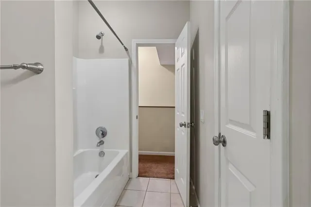 a view of an empty room with cabinet and entryway