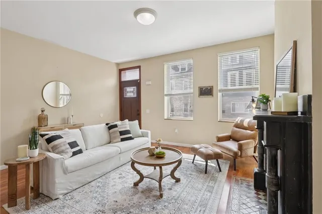 a living room with furniture a fireplace and a flat screen tv