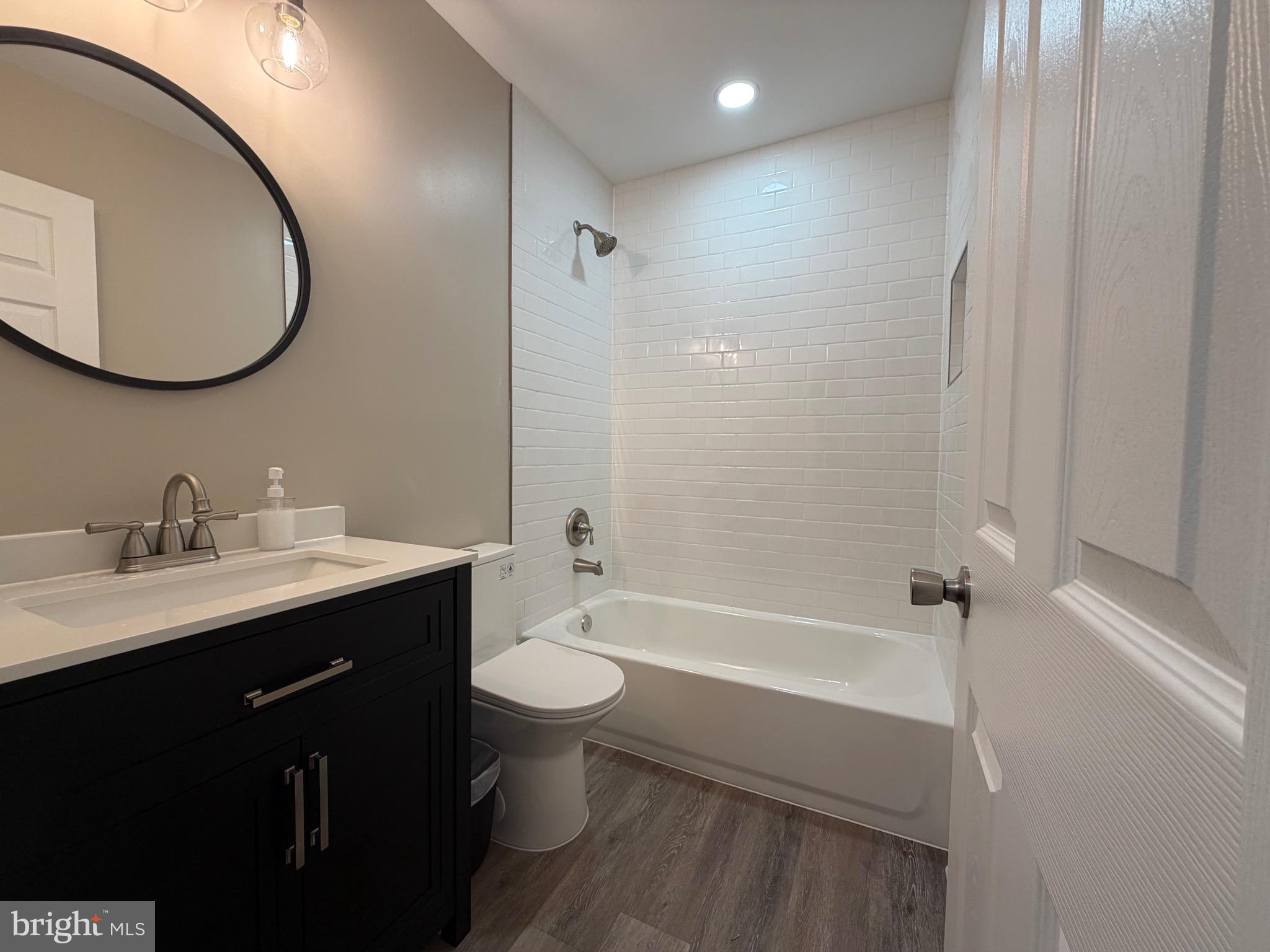 41010 New Market Turner Road Mechanicsville, MD 20659 - Photo 11 of 14 2nd bath with black vanity & tiled tub surround