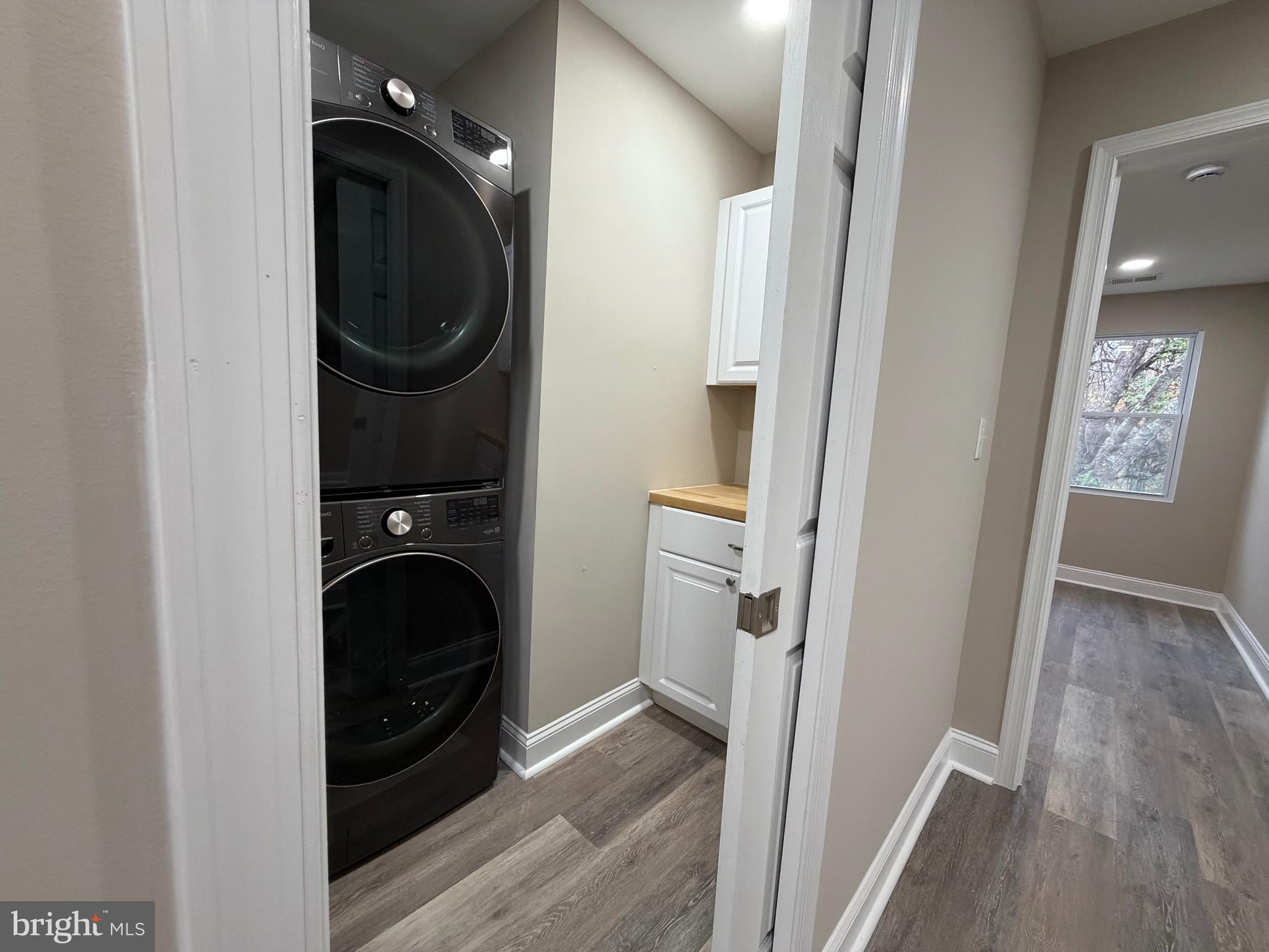 41010 New Market Turner Road Mechanicsville, MD 20659 - Photo 5 of 14 Laundry room with stacked washer/dryer & cabinetry