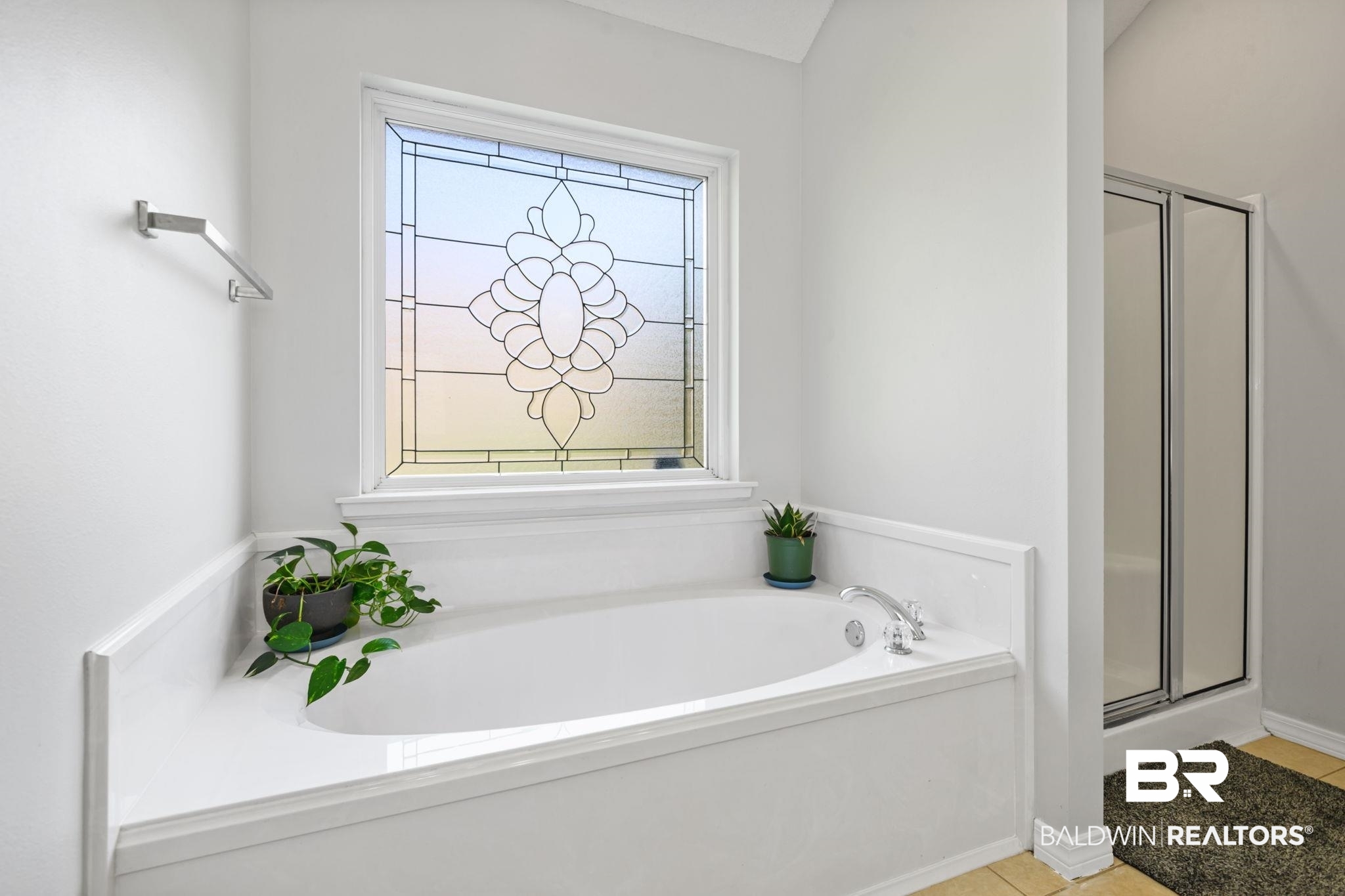 9422 Labrador Run South Mobile, AL 36695 - Photo 21 of 36 Built-in soaking tub with a decorative privacy window, chrome fixtures, and a glass-enclosed shower