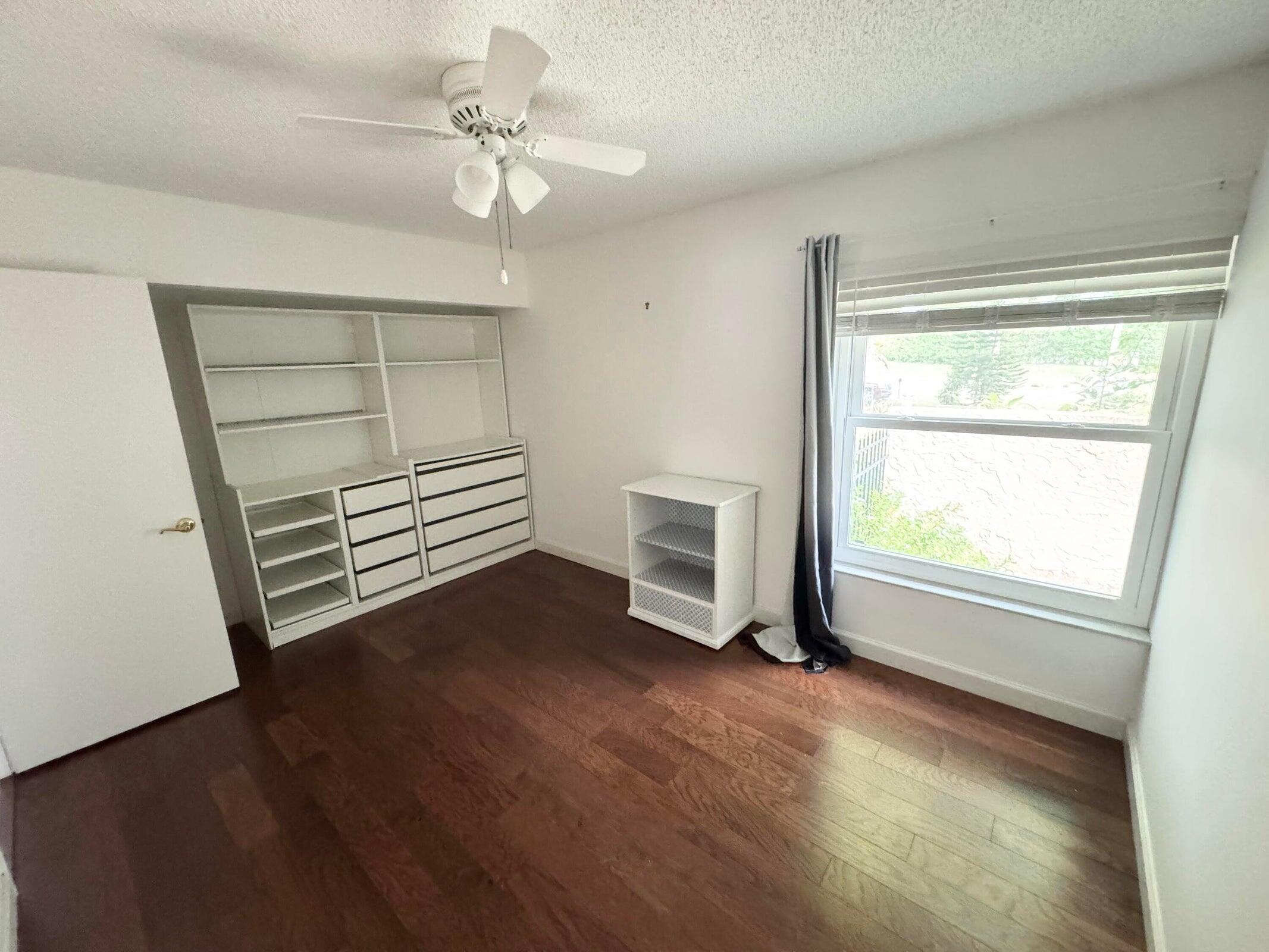 23261 Boca Club Colony Circle Boca Raton, FL 33433 - Photo 14 of 17 wooden floor in an empty room with a window