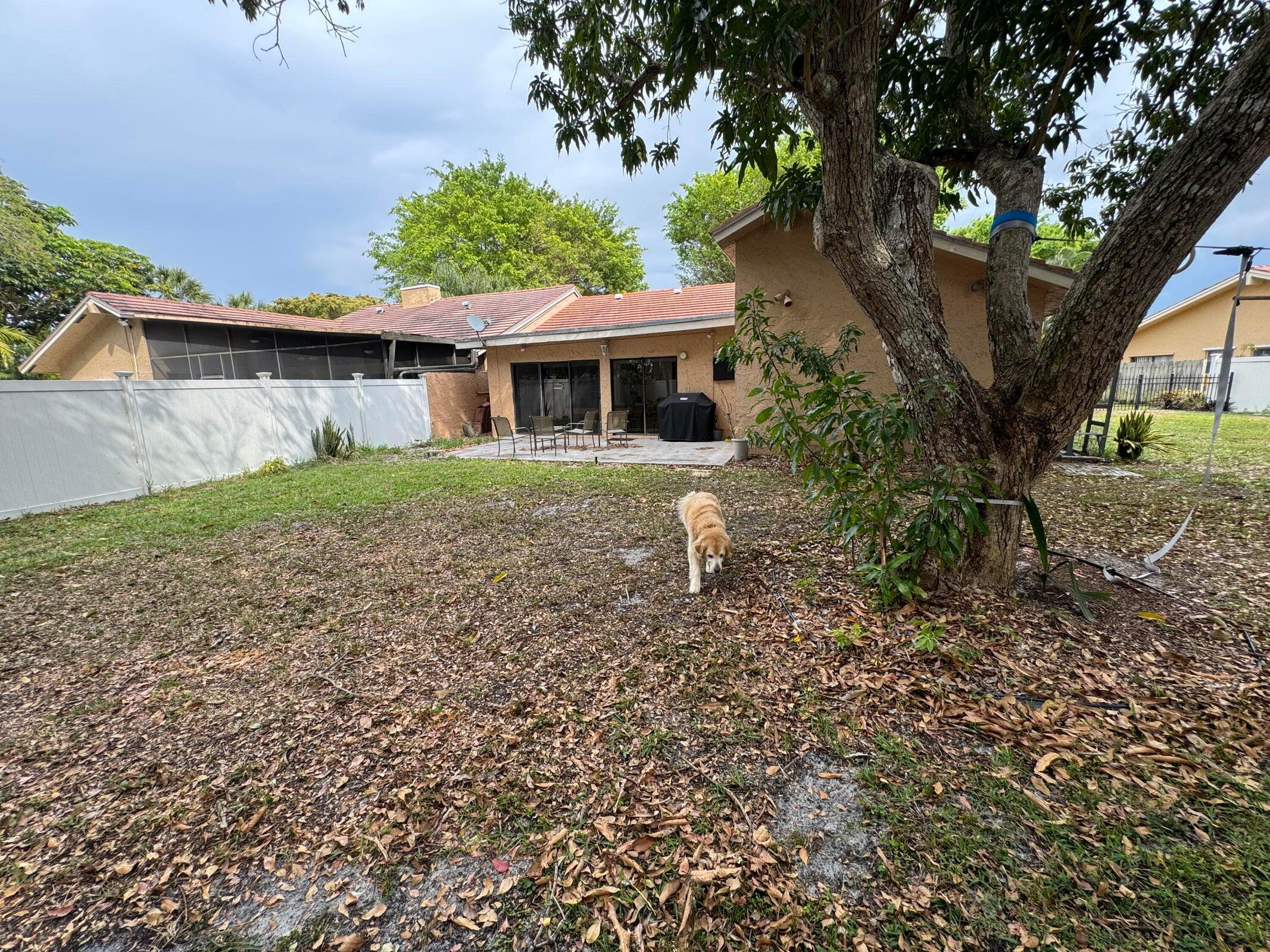 23261 Boca Club Colony Circle Boca Raton, FL 33433 - Photo 2 of 17 a front view of a house with a yard