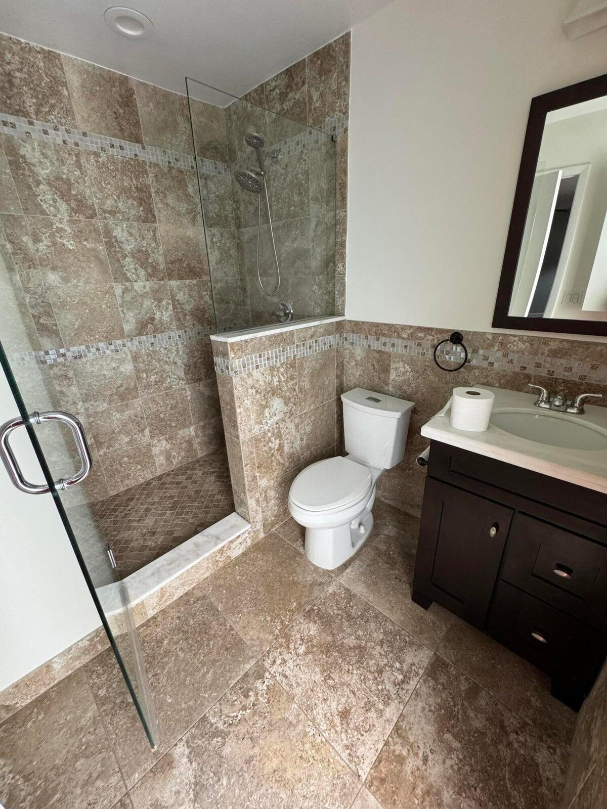 23261 Boca Club Colony Circle Boca Raton, FL 33433 - Photo 8 of 17 a bathroom with a sink a toilet and a mirror