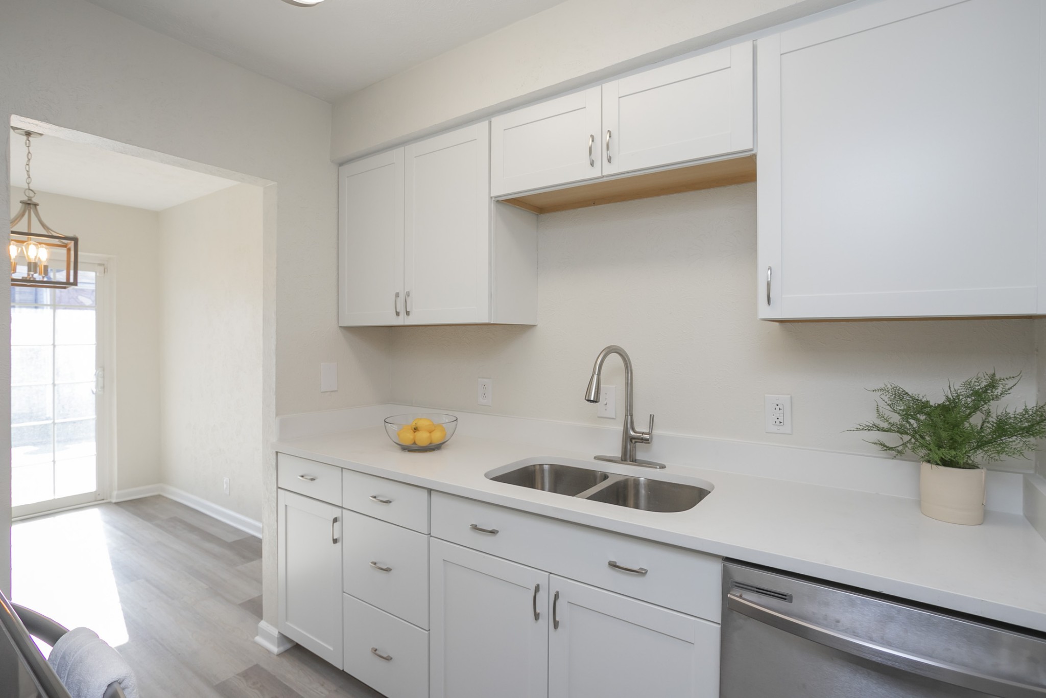 810 Bellevue Road, Unit 214 Nashville, TN 37221 - Photo 10 of 27 a kitchen with white cabinets a sink and dishwasher