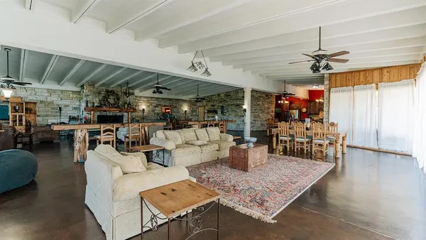 a living room with lots of furniture and a chandelier