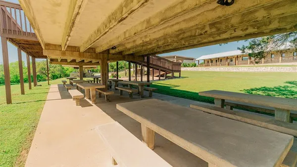 a backyard of a house with table and chairs