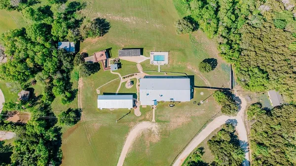 an aerial view of a house with a backyard