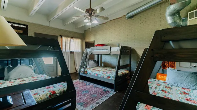 a living room with furniture and a baby crib