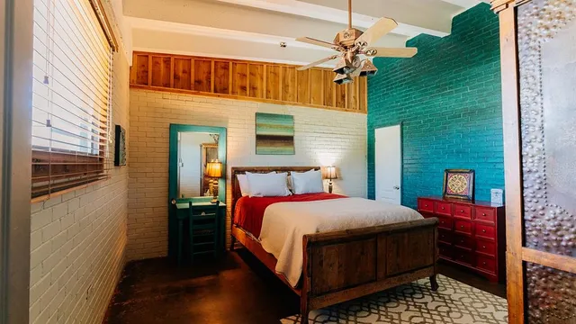 a bedroom with a bed dresser and a window