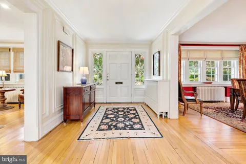 a living room with stainless steel appliances furniture and a table