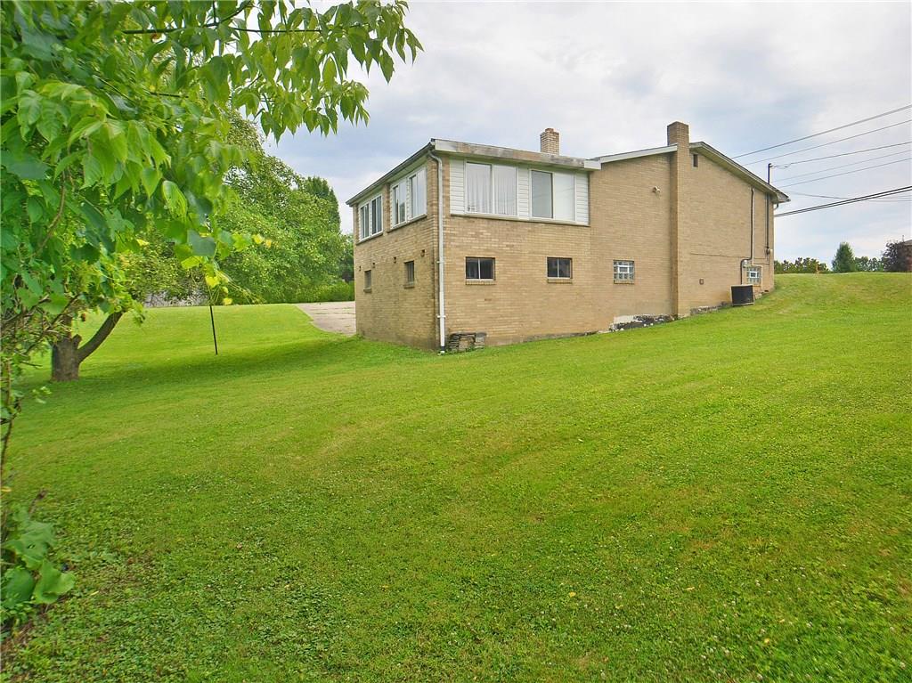 14111 Ridge Road North Huntingdon, PA 15642 - Photo 21 of 24 Side/rear view of the yard - surrounded by greenery