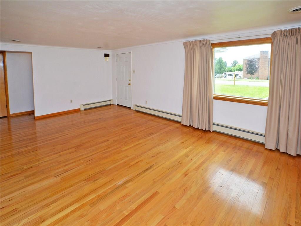 14111 Ridge Road North Huntingdon, PA 15642 - Photo 6 of 24 Nice size living room with large picture window, hardwood flooring throughout living room and all bedrooms, hallway.