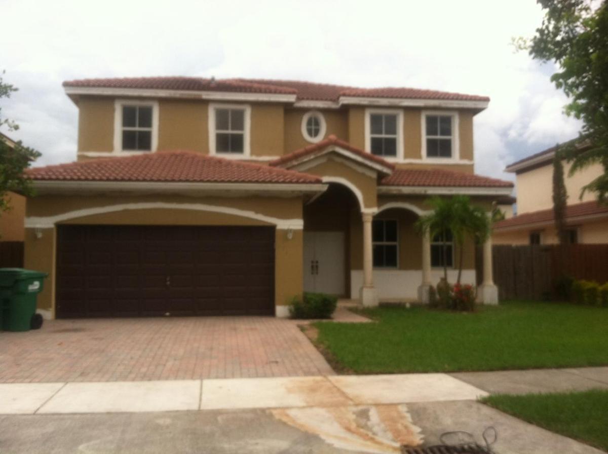 1441 Southwest 145th Place Miami, FL 33184 - Photo 1 of 1 a front view of a house with garden