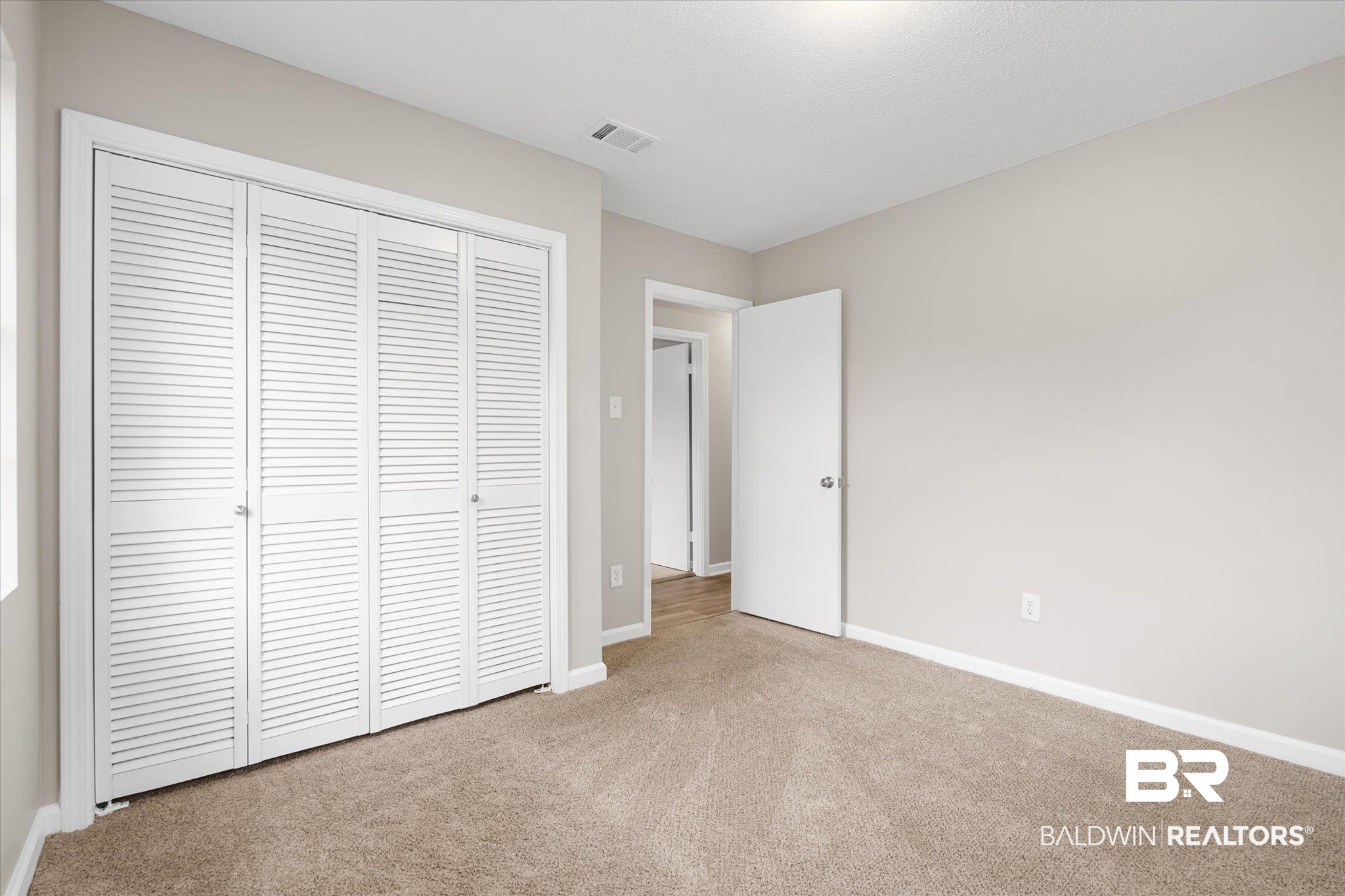 5015 Golfway Drive Eight Mile, AL 36613 - Photo 17 of 31 Unfurnished bedroom featuring a closet and light colored carpet