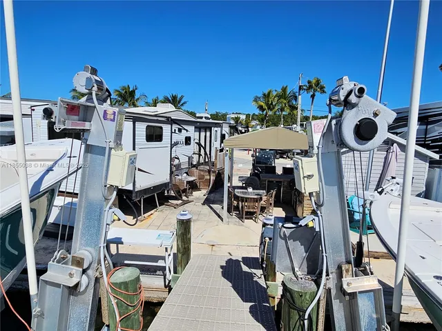 a roof deck with a table and chairs with wooden floor